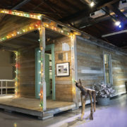 1-Travis-Whitfield-“Shotgun-House”-Installation-with-objects-photos.-Foreground-Jesse-Lott-“Junkyard-Dog”-1990s-Found-wood-mixed-media.-Image-from-Station’s-website