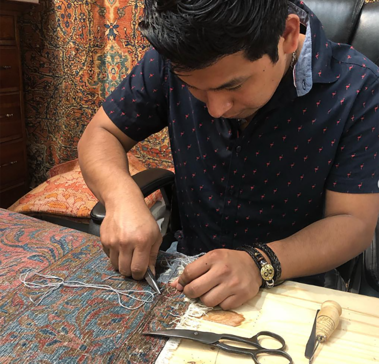 13-Adan-Martinez-repairs-a-rug