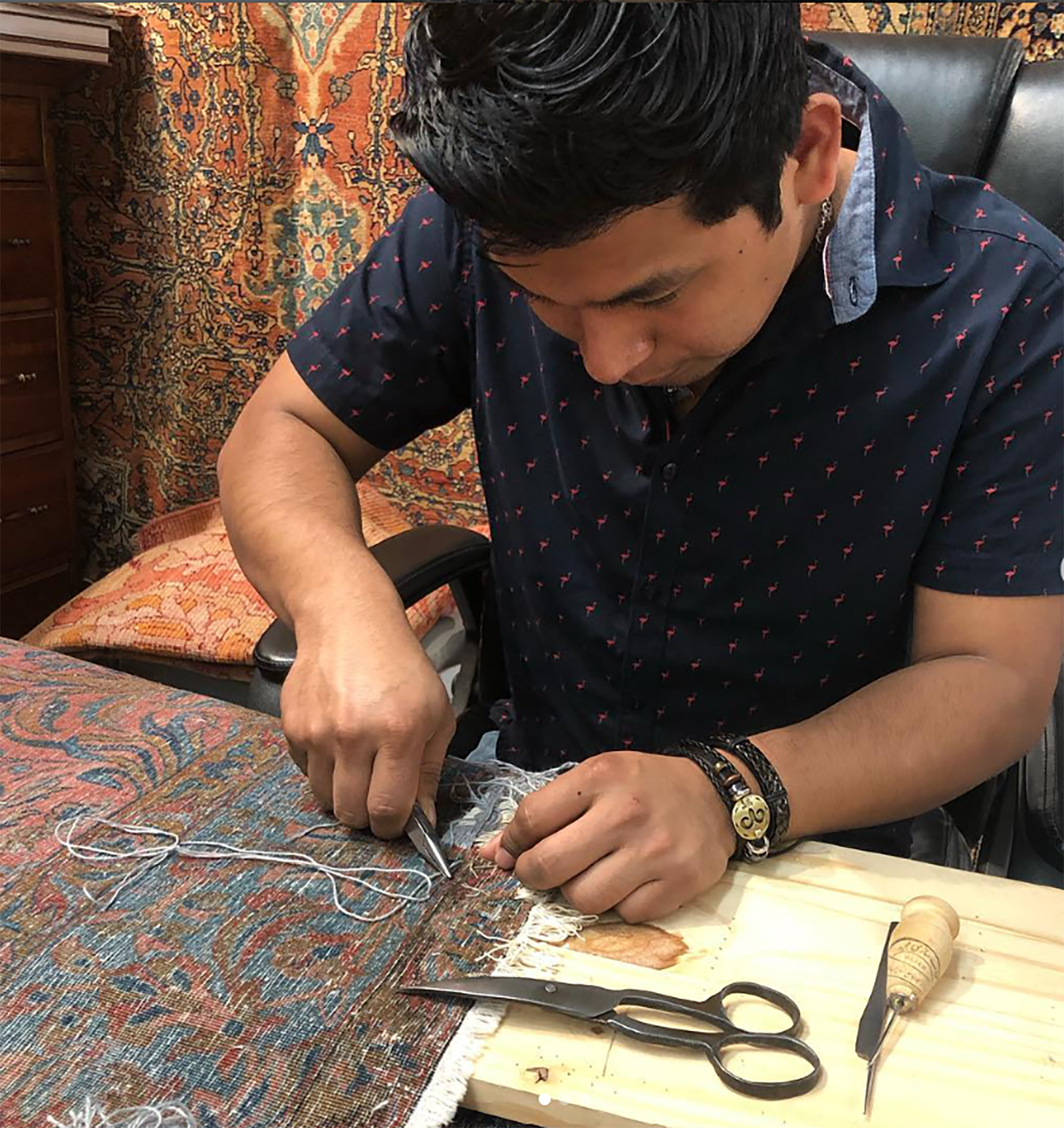 13-Adan-Martinez-repairs-a-rug