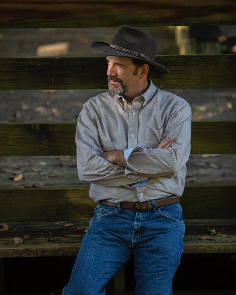 John-leaning-against-fence