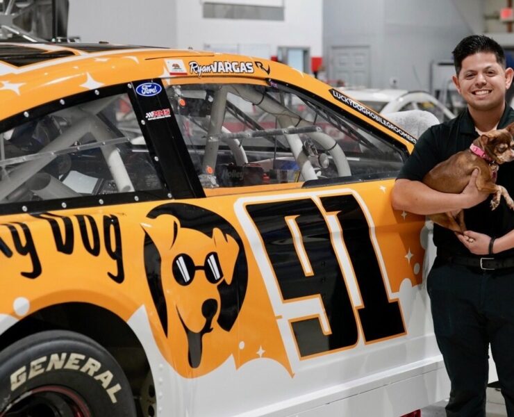 NASCAR driver Ryan Vargas and his dog Bean in front of the Lucky Dog car