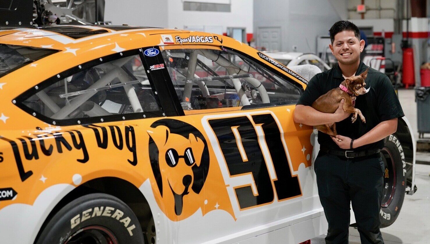 NASCAR driver Ryan Vargas and his dog Bean in front of the Lucky Dog car